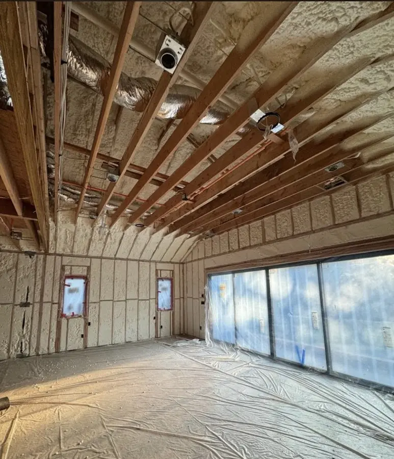 Interior walls and ceiling insulated with spray foam during new construction in Delhi